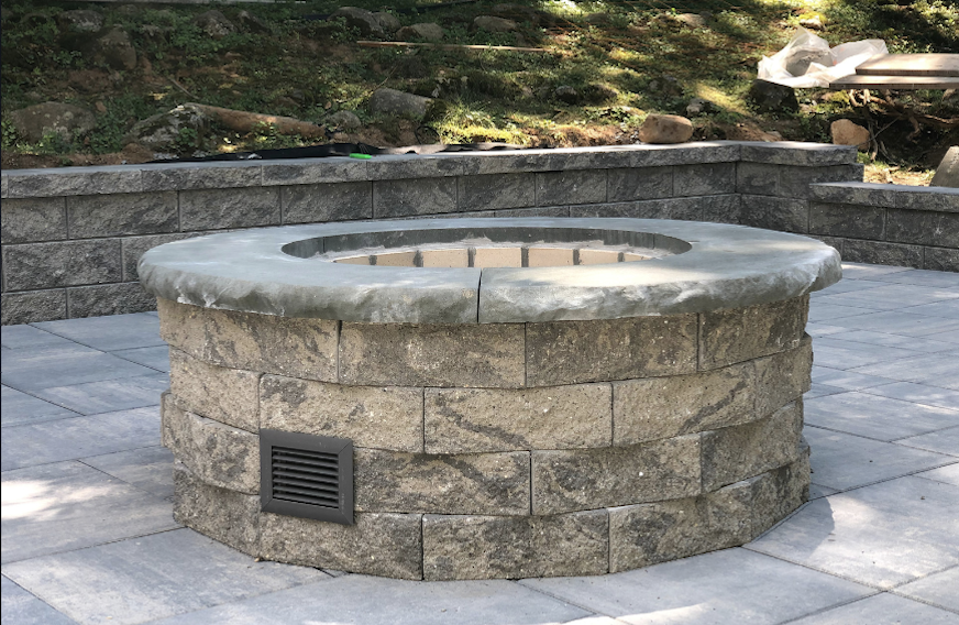 Newly installed block fire pit on a paver patio in Essex Fells, Essex County, NJ, by Masonry Pro Construction
