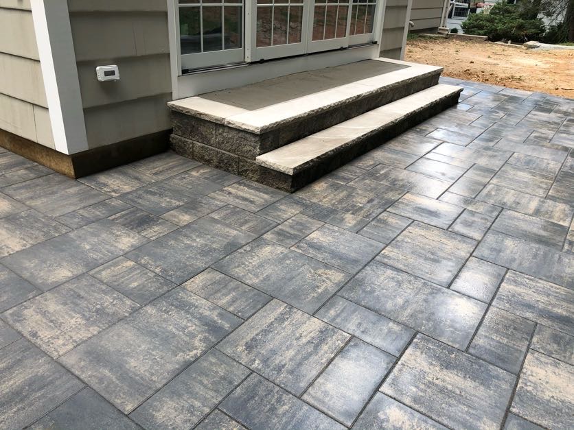 Patio waterproofing installation in Essex Fells, New Jersey, featuring a sealed paver patio and steps designed to protect the foundation and prevent water intrusion.