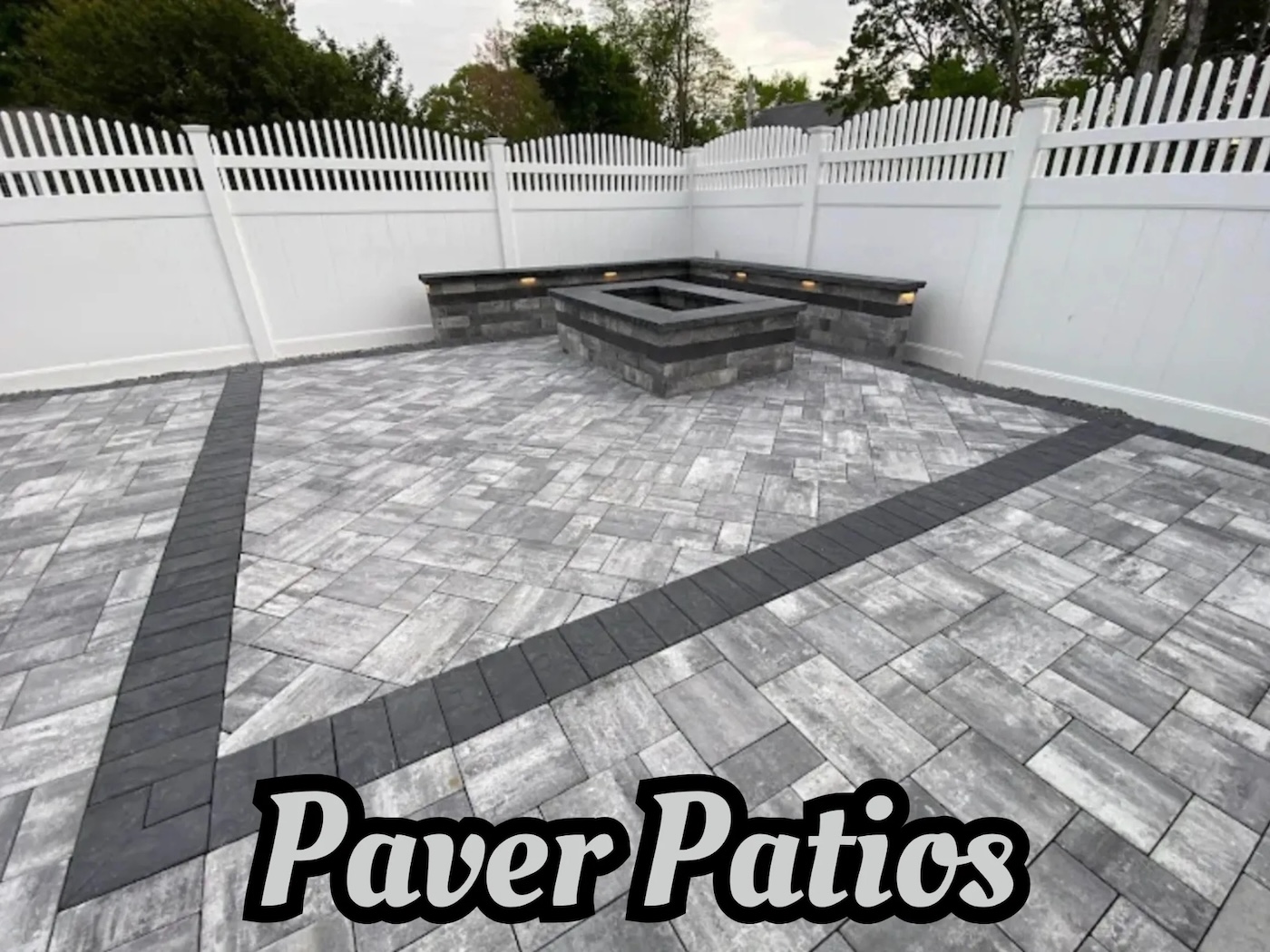 Paver patio with an integrated fire pit and seating in Bloomfield, Essex County, NJ. by Masonry Pro Construction